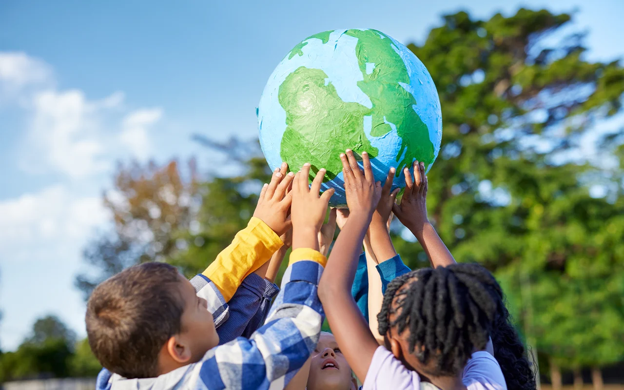 children holding up earth toy